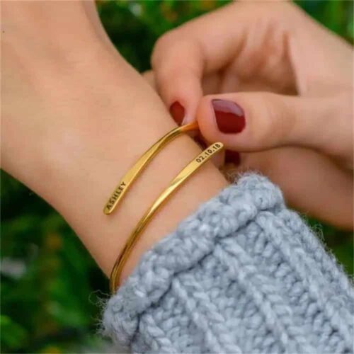 adjustable name cuff bangle in gold stainless steel with two personalised names engraved on the cuff
